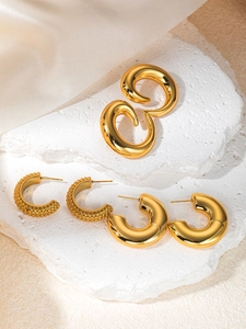 Detailed macro view of three styles of textured and smooth 18K gold plated hoop earrings
