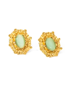Detail of vintage gold-plated titanium earrings featuring oval green cat-eye stones