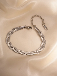 Detail view of a polished silver braided snake chain necklace with lobster clasp