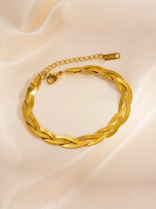 Detail of gold twisted braid necklace made of triple-strand snake chains in stainless steel