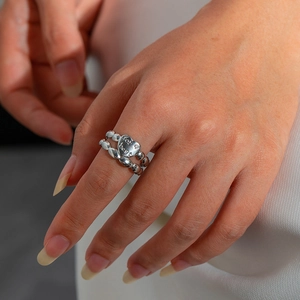 Close-up of silver bead heart ring with for best engraving on a model's finger