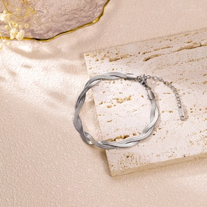 Detail of silver twisted herringbone chain showing S.Steel engraving and lobster clasp