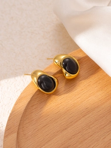 Detailed view of vintage gold titanium steel earrings with elegant black oval stones