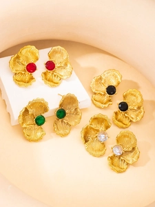 Detailed macro view of vintage petal earrings set with colorful zircon and gold plating