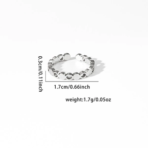 Detail view of adjustable silver open ring with circular hollow patterns and dimensions