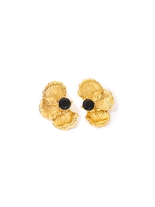 Macro detail of gold flower petal earrings featuring a central black faceted zircon stone