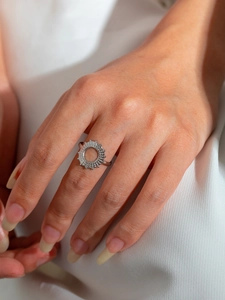 Close-up of minimalist silver titanium steel ring with hollow circular geometric design