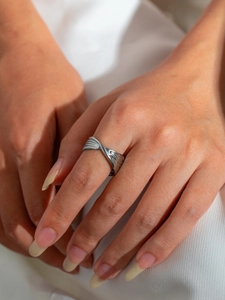 Macro shot of twisted silver titanium steel ring with radiating stripe texture detailing