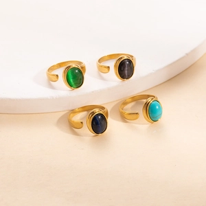 Set de 4 anillos dorados de titanio con piedras ovales verdes, azules y negras en base