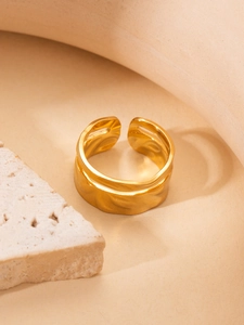Detailed macro shot of an 18K gold-plated titanium ring with irregular lava texture