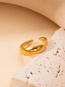 Minimalist C-shaped open ring in matte gold finish on natural textured stone