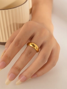 Close-up of minimalist matte 18K gold-plated titanium ring on a model's finger