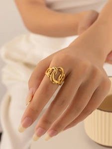 Macro shot of 18K gold plated titanium ring with interwoven twisted chain design