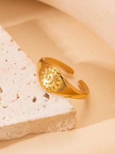 Detail of 18K gold-plated vintage signet ring with a sun motif and spiral carving