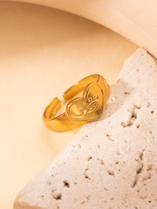 Detailed shot of an 18K gold plated heart ring with an evil eye engraving on a stone