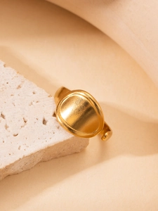 Detail of vintage gold-plated titanium steel ring with adjustable open band on stone