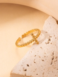 Detailed view of an 18K gold plated beaded open ring with a small cross on a stone