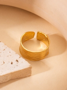 Detailed view of 18K gold plated titanium steel ring with hammered vintage texture