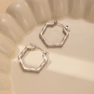 Minimalist silver hexagon earrings with bamboo texture and secure snap closure