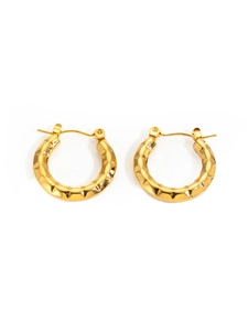 Detail of gold titanium steel hoop earrings featuring a unique hammered geometric texture