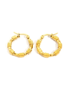 Detailed macro view of gold-plated titanium hoop earrings with vintage twisted bamboo texture