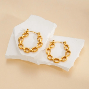 French vintage gold plated titanium chain link hoop earrings on white stone display