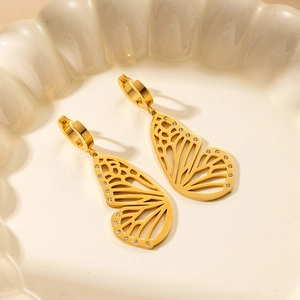 Detail of gold butterfly wing earrings with hollow design and inlaid white zircons