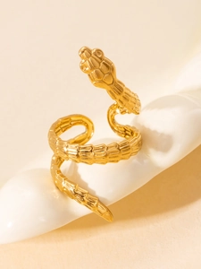 Macro view of gold snake ring featuring detailed scale texture and wrap-around design