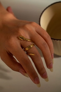 Detailed view of a vintage gold snake-shaped triple finger ring with realistic scales