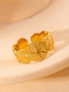 Detailed macro view of gold-plated celestial star pattern ring with bohemian engraving