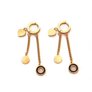 Detailed shot of gold titanium steel tassel earrings with heart and black enamel charms