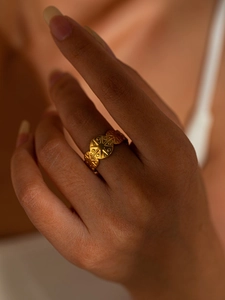 Macro shot of gold-plated titanium steel ring featuring star pattern and embossed details