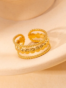 Macro shot of gold-plated titanium steel layered ring with polished bead chain design
