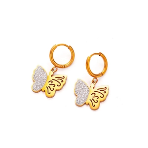 Detailed macro view of gold-tone butterfly hoop earrings with crystals and hollow design