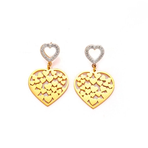 Detail of gold hollow heart earrings with crystal encrusted studs on white background