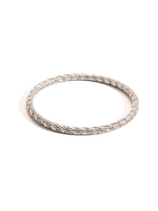 Macro detail of silver titanium steel bangle with elegant diamond-cut texture pattern