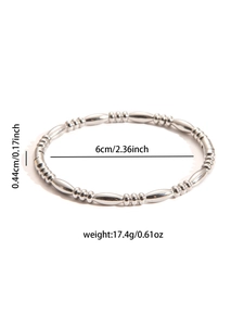 Macro shot showing dimensions of silver titanium steel bangle with beaded segments