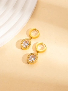Detailansicht der goldenen Creolen mit großem ovalem Zirkonia und Pavé-Diamanten