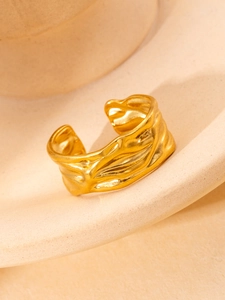 Macro view of adjustable golden titanium steel ring with irregular lava wave texture design