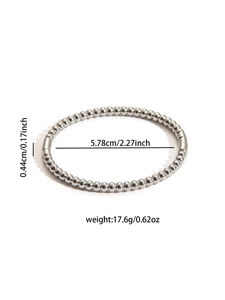 Detail view of silver bead bracelet showing 5.78cm inner diameter and 0.44cm bead width