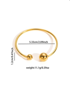 Detail view of 18K gold plated titanium bangle with ball ends and 5.33cm inner diameter