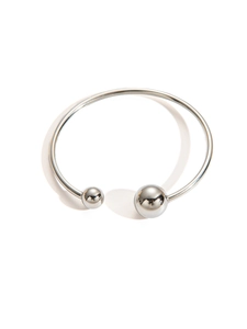 Macro shot of silver titanium steel open bangle with dual polished metal beads