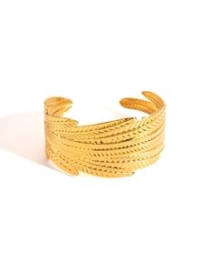 Detail shot of golden titanium steel bangle featuring layered feather texture and high luster