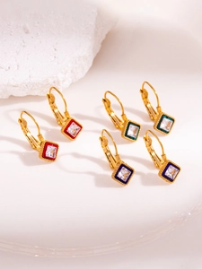 Detailed view of vintage gold earrings with colorful enamel frames and square zircons