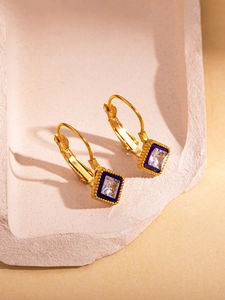 Detailed close-up of 18K gold-plated earrings with blue enamel and square zircon crystals
