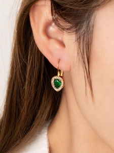 Close-up of 18K gold plated drop earrings featuring a green emerald-like pear-cut stone