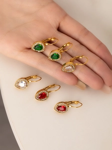 Macro view of teardrop emerald and ruby earrings with 18K gold plated leverback settings