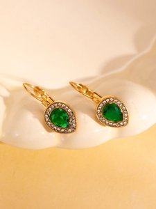 Detailed close-up of retro lever-back earrings with green pear-cut stones and gold plating