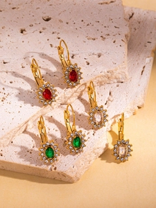 Detailed macro view of 18K gold-plated leverback earrings with oval colorful gemstones