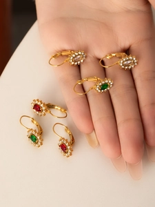 Detail of vintage flower leverback earrings in gold plating with colorful stones